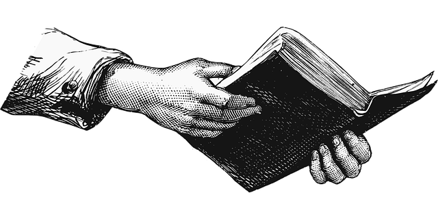 a hand holding a Bible