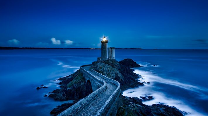 a lighthouse at the water's edge