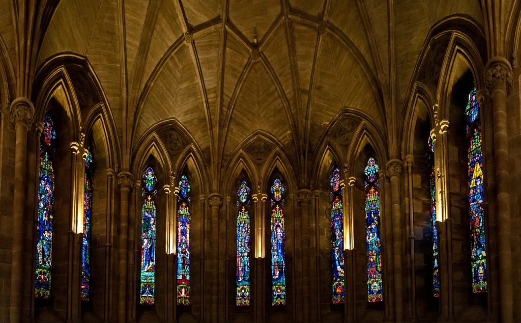 a wall of stained glass at an abbey