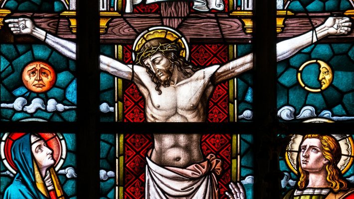 A stained glass window of Jesus on the cross