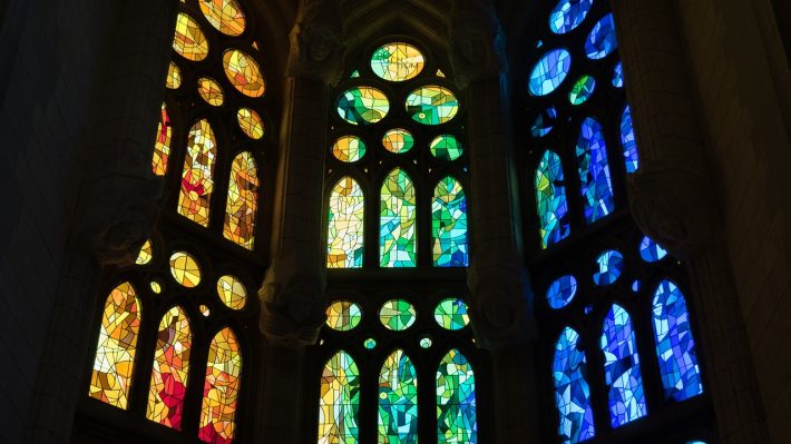 A wall of stained glass in a gothic church